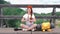 Female tourist traveler sits and rests with a backpack on a railway track on a bridge. A girl