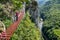 Female tourist on a via ferrata bridge in Vadu Crisului, Padurea Craiului mountains, Romania, with the Crisul Repede defile/gorge