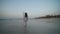 Female tourist walking on the beach in Dubai in front of Burj Al Arab