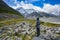 Female tourist is watching Panorama view the mueller glacier and mueller lake at kea point