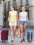 Female tourists exploring old european city with baggage
