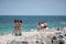 Female tourists in Miami Beach taking selfie photos on the jetty with ocean in background