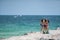 Female tourists in Miami Beach taking selfie photos on the jetty with ocean in background