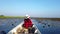 Female tourists take a longtail boat for a tour around Thale Noi, Phatthalung Province, Thailand