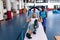 Female trainer assisting disabled active senior woman to exercise in sports center