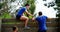 Female trainer assisting fit man to climb over wooden wall during obstacle course 4k