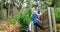 Female trainer assisting fit woman to climb over wooden wall during obstacle course 4k