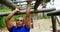 Female trainer clapping hands while fit man climbing monkey bars 4k