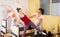 Female trainer controlling young woman doing pilates on reformer