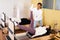 Female trainer controlling young woman doing pilates on reformer