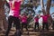 Female trainer instructing women while exercising in the boot camp