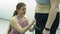 Female Trainer Measuring Leg of Plump Woman