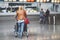 Female travel tourist pushing trolley with luggage at airport terminal. Unrecognizable faceless woman going to airline