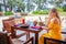 Female traveler enjoys healthy lunch at tropical beach restaurant