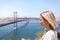 Female traveler enjoys panoramic views of Lisbon and the bridge of April 25