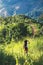 A female traveler hiking through the greenery mountains