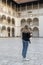 Female traveler in historical places looks around courtyard of landmark in Krakow Wawel castle. Tourist in historic