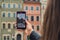 Female traveler in historical places looks around courtyard of landmark and shoots short video on phone In Warsaw Poland