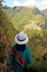 Female traveler impressed by the amazing aerial view of the Inca citadel ruins of Machu Picchu view from Huayna Picchu mountain,