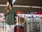 Female traveler in mask standing near gates on station