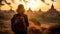 Female traveler photographing temples at Bagan Myanmar Asia at sunrise