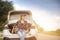 A female traveler rides a hatchback in the light and trees and the morning sky