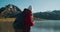 Female traveler shoot landscape scenery on lakeside shore on hike journey