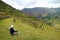 Female Traveler Sitting on the Ancient Inca Agricultural Terraces at Pisac Archaeological site, Sacred Valley, Cusco region, Peru