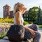 Female traveler sitting and enjoys the view of Wawel Castle.