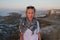 Female traveler standing on city fortress wall of Essaouira, Morocco in sunset.