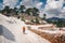 Female traveler walking down the snowy mountain in Turkey