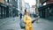 Female traveller looks at a map while standing on a street.