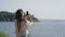 Female traveller is photographing sea view by smartphone