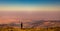 Female trekker enjoys the view from the summit of Jbel Toubkal, Atlas Mountains, Morocco.