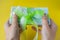 Female two hands holding a pack of hundred euro banknotes with green bow-knot, gift or dividends concept, european union money