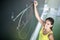 Female university student in front of a blackboard solving a problem