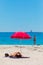 Female vacationers suntanning on sandy beach