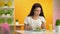 Female vegetarian eating fresh salad sitting cafe, orange juice glass on table