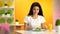 Female vegetarian eating fresh salad sitting cafe, orange juice glass on table