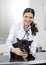 Female Vet Examining French Bulldog With Stethoscope On Bed