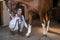 Female vet examining horse in stable