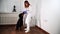Female vet puts plastic elizabethan medican collar on the black dog