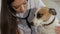 Female veterinarian checks up the dog`s breath