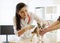 Female veterinarian examining teeth of Spitz dog in clinic