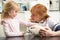 Female Veterinary Surgeon Examining Guinea Pig