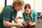 Female Veterinary Surgeon And Nurse Examining Cat