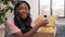 Female video blogger opening parcel box at home