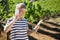 Female vintner using digital tablet while talking on mobile phone