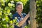 Female vintner working in vineyard