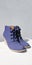 Female violet suede boots on grey background, isolated product, top view